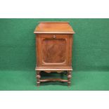 Mahogany music cabinet the top having raised back and moulded edge over fall front door opening to
