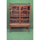 Mahogany glazed bookcase having 3/4 raised gallery formed of turned spindles with moulded top rail