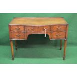 Mahogany serpentine fronted writing table having central drawer flanked by two short drawers to