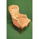 Victorian buttoned spoon back ladies armchair having pale gold upholstery and shaped seat front,