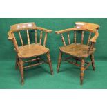 Two late 19th/early 20th century smokers bow chairs having sweeping arms supported by turned