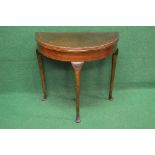 20th century mahogany demi lune fold over card table having cross banded top opening to reveal
