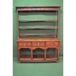Period oak dresser the plate rack having moulded cornice over three fixed shelves with metal hooks,