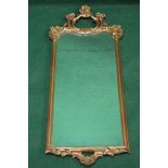 20th century gilt framed wall mirror having scrolled decorated top and further scrolled and shell