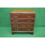 20th century mahogany chest of drawers the top having moulded edge over brushing slide with brass