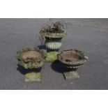Circular garden urn having scrolled top with gadrooned body,