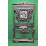 Oak carved hall stand having central bevelled mirror surmounted by carved frame work and six