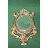 Possibly French brass framed wall mirror having oval bevelled glass surmounted by an ornate pierced