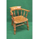 Victorian captains chair having scrolled arms and back supported by turned spindles leading to an
