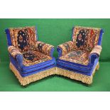 Pair of upholstered blue armchairs having padded back, arms and seats,