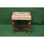 Walnut dressing stool having floral embroidered padded seat supported on turned legs with X formed