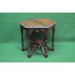Oak hexagonal occasional table the top having carved edge over a shaped and carved frieze,