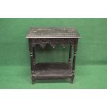 Rectangular dark oak occasional table having carved top with moulded edge over a carved frieze with