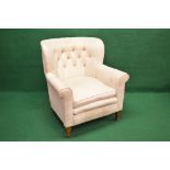 Buttoned back tub style armchair with scrolled arms and removable seat cushion with straight front,