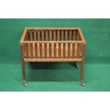 Arts & Crafts style oak planter having slatted sides and standing on square moulded legs ending in