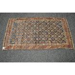 Blue ground rug having red,