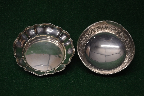 Circular silver dish having shaped edge,