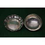 Circular silver dish having shaped edge,