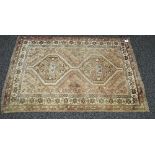 Red faded ground rug having brown pattern with cream border and end tassels - 39" x 58.