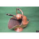 Victorian copper coal helmet having turned wooden handle together with matching copper scoop with
