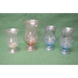 Group of four 20th century glass candle holders having bubble inclusions,