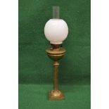 Brass oil lamp having white glass globe and clear glass chimney with a brass burner and reservoir