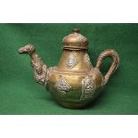 Large Persian brass teapot having applied decoration of face masks,