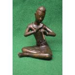 20th century bronze figure of a young man in a seated position playing a flute with tilted head - 9.