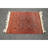 Red and brown ground patterned rug with end tassels - 32.