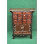 20th century Oriental style apothecary cabinet the top having up turned ends over two longer
