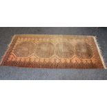 Light brown ground rug having dark brown pattern with end tassels - 85.