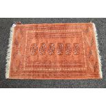 Rust ground patterned rug with end tassels - 25.