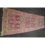 Red and blue ground carpet runner having gold, pink and cream pattern with end tassels - 35.
