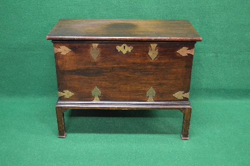 Mahogany chest on stand having brass mounts, escutcheon and side carrying handles,