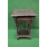 Heavily carved decorative possibly Eastern occasional table the top being carved with figures,