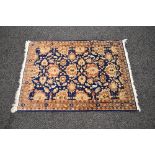 Blue ground rug having brown and cream pattern with end tassels - 40" x 56"