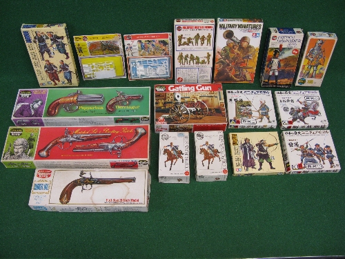 Seventeen boxed plastic kits of guns, soldiers and warriors from various eras by Airfix, Tamiya,