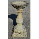20th century circular bird bath the top supported on a bulbous column leading to a shaped square