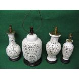 Group of four Oriental white glazed reticulated lamps of various heights and forms Please note