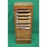 Oak tambour fronted filing cabinet the front dropping to reveal fitted interior of slides - 17.25"