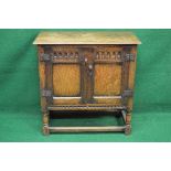 20th century oak Jacobean style side cabinet having two panelled doors and standing on stretchered