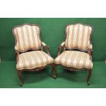 Pair of 20th century mahogany showwood framed armchairs having padded back, arms and seat,