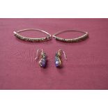 Pair of gold and Amethyst pendant earrings, each claw set with a pear shaped Amethyst to the drop