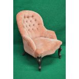 Button back tub armchair having shaped seat front, standing on cabriole legs ending in castors