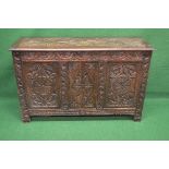 Tall oak carved coffer the top opening to reveal storage space, standing on carved stile feet -