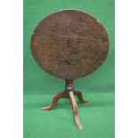 Circular oak tip top occasional table the top supported on a turned column, standing on a tripod