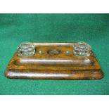 Walnut desk stand having two glass inkwell separated by circular central dish and two pen trays -