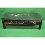 20th century lacquered chinoiserie style coffee table having protective glass top over three drawers