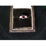 18ct gold ladies ring set with single oval cut ruby flanked by single circular cut diamonds (gross