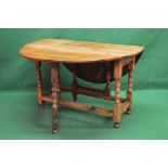 20th century oval drop flap dining table having bow ends and supported on stretchered block and